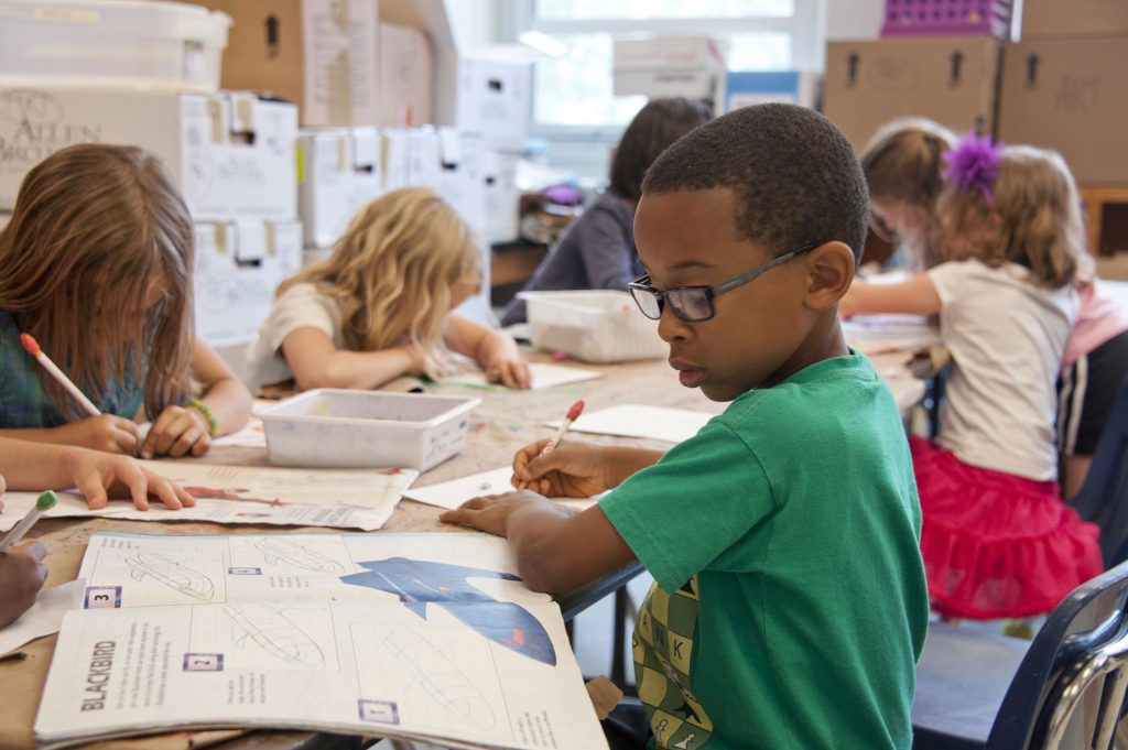 children in a classroom sitting at desks