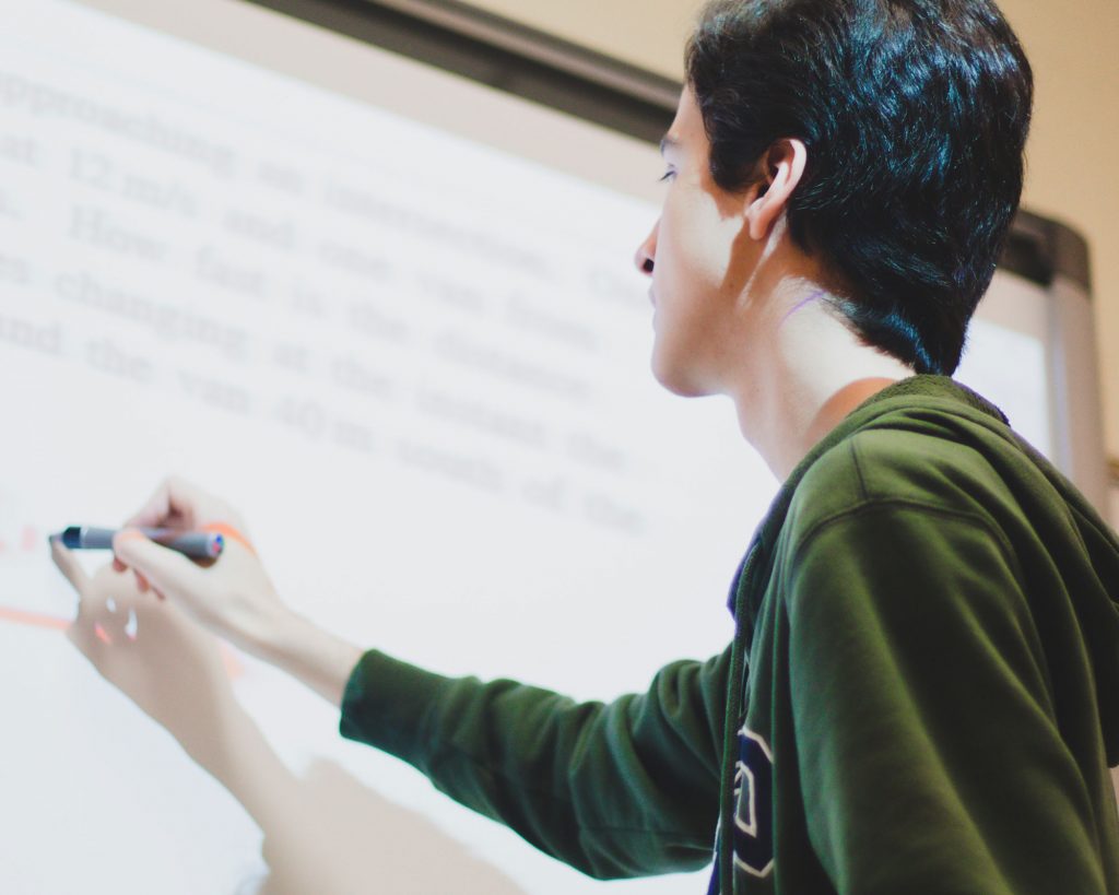 teacher using interactive projector board